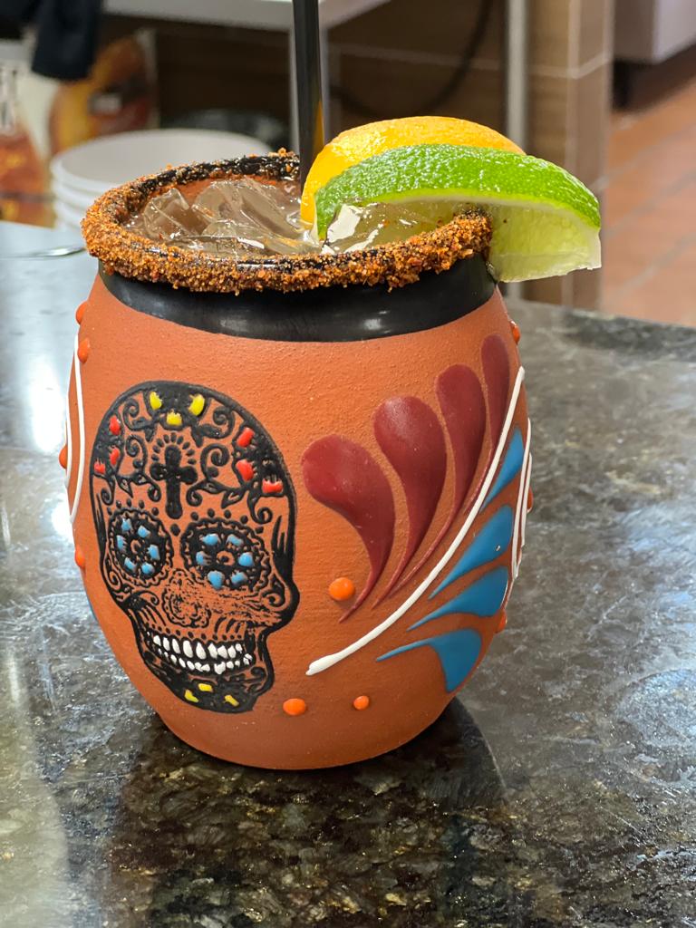 Chile-rimmed margarita served in a hand-painted clay cup